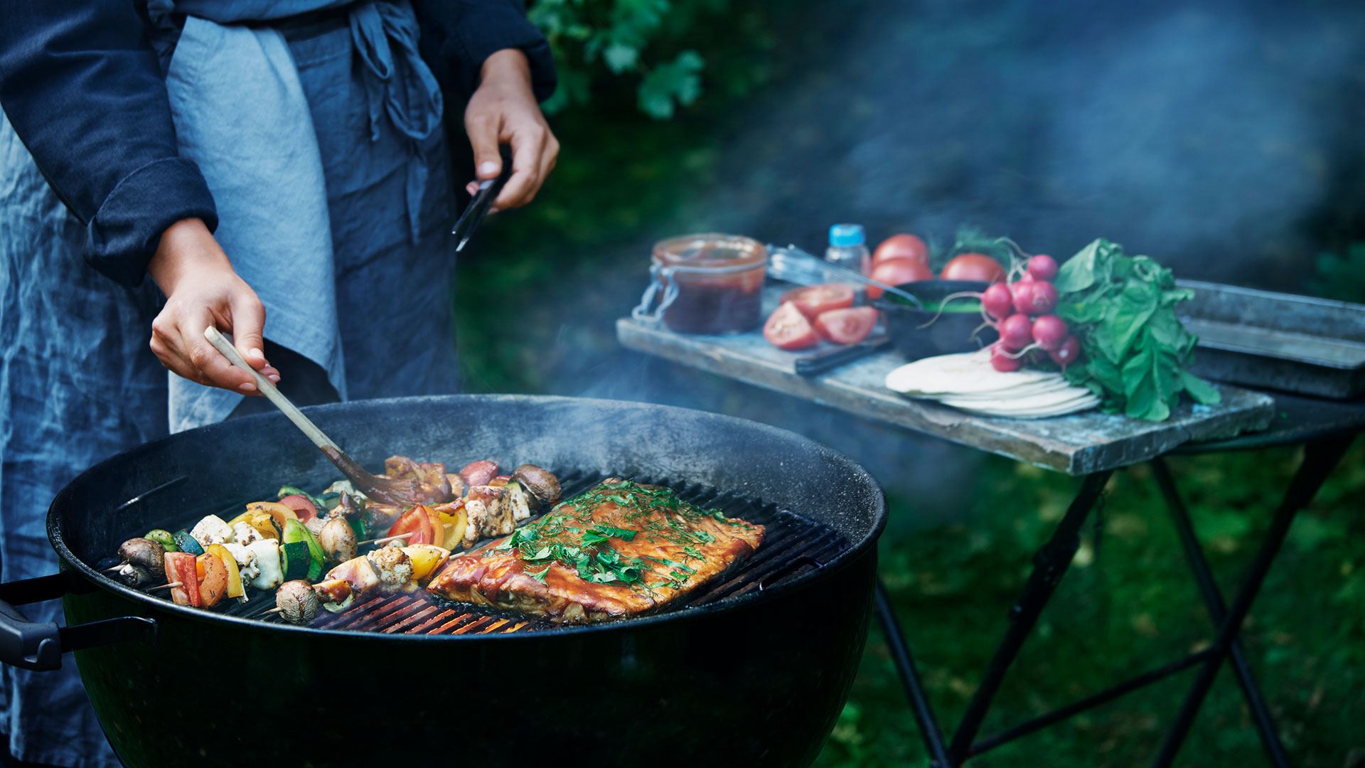 BBQ grilling salmon and vegetable skewers