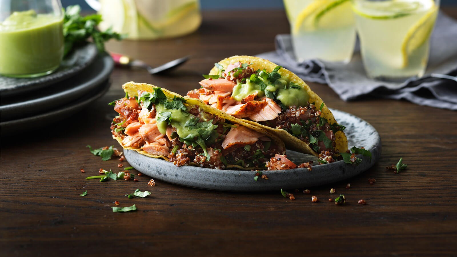 Two salmon tacos served on a plate