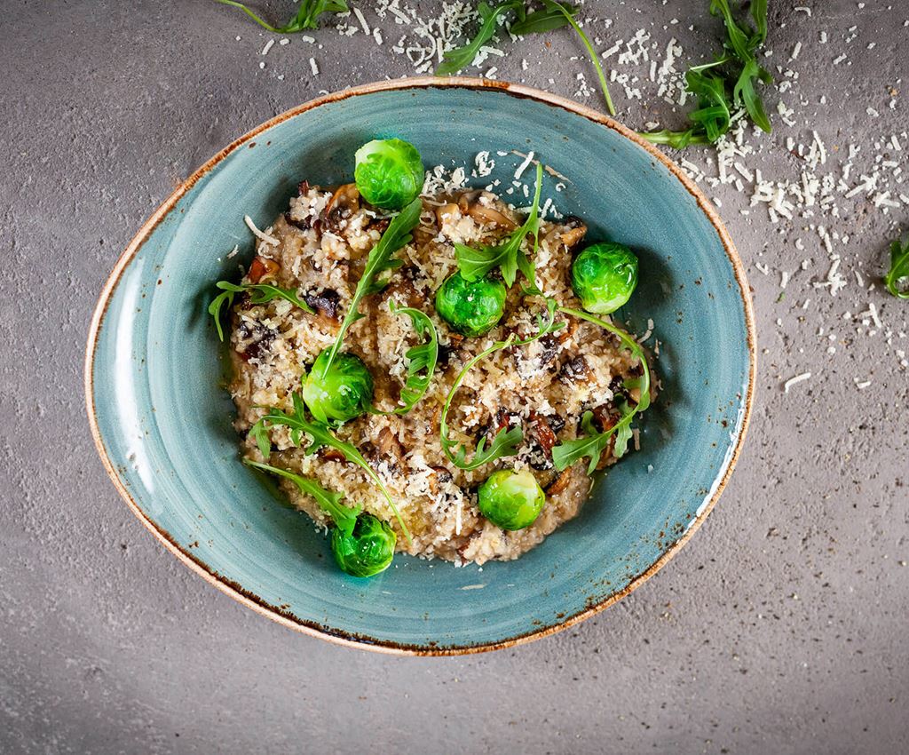 Dish with pearl barley risotto with mushrooms and brussels sprouts