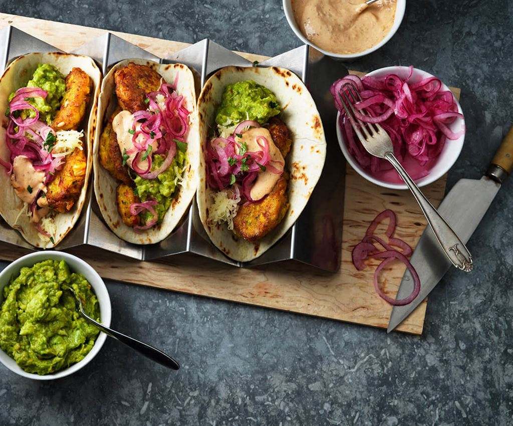 Three tacos with corn fritters and guacamole