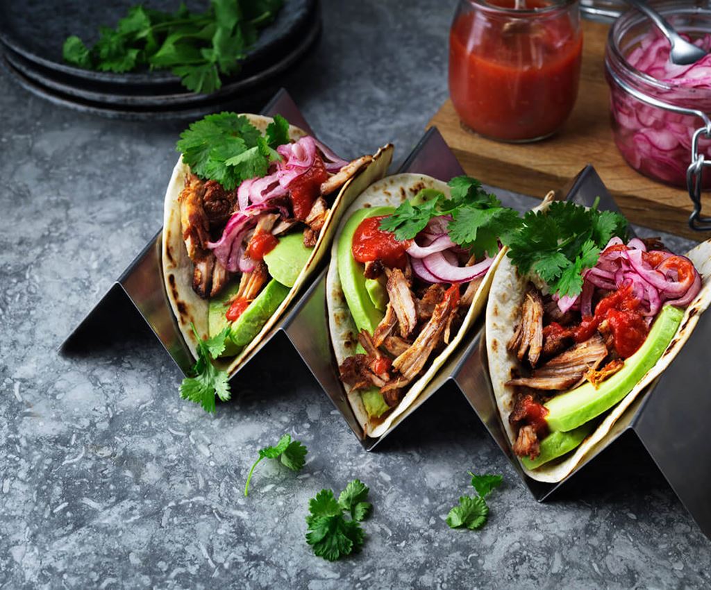 Three pulled pork taco on a tray